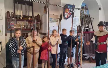 dzieci trzymające broń kt&oacute;rą używali rycerze krzyżaccy