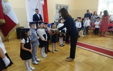 Pani Dyrektor wielkim oł&oacute;wkiem pasuje na ucznia pierwszoklasist&oacute;w